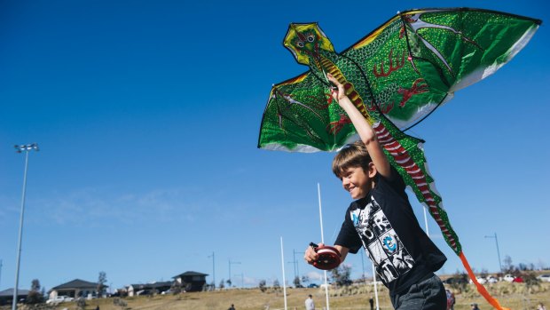 Macca Cleary, 9, of Queanbeyan trying to get his kite up despite a lack of wind at Flying High in the Googong Sky on Sunday morning.
