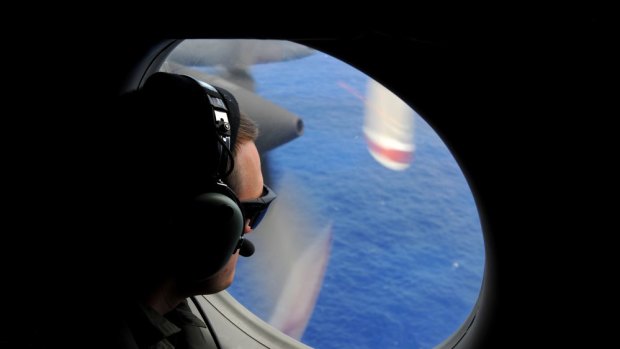 A crew member of a Royal New Zealand Airforce help to look for objects from the missing Malaysia Airlines flight MH370 flight.