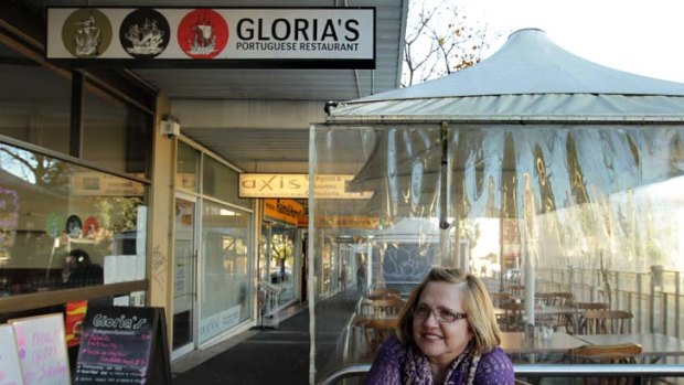 Alfresco ... Gloria Belinha sits at a table outside her Portuguese cafe in Petersham that she can now provide without paying a fee to Marrickville Council.