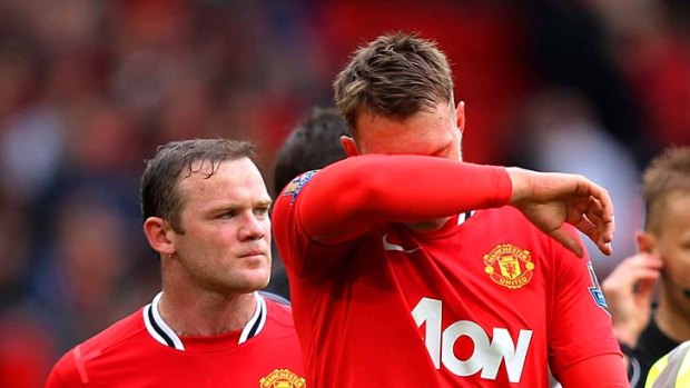 Points lost: United's Wayne Rooney (left) and Phil Jones walk off after the draw.