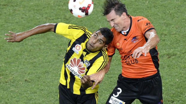 Shane Stefanutto of the Roar and Roy Krishna of the Phoenix compete for the ball.