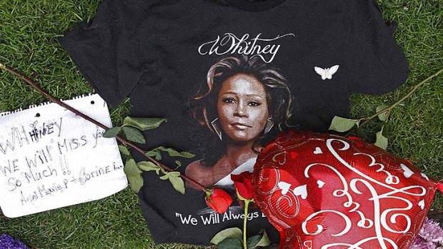 Tribute ... A T-shirt, flowers and notes are left at a makeshift memorial for Whitney Houston outside the Beverly Hilton Hotel.