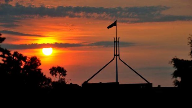 The sun sets over Parliament House.