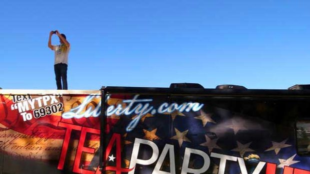 A man takes a picture from the top of a bus at a rally for the Tea Party Express national tour, which kicked off last week in Reno, Nevada.