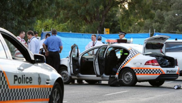 Similar circumstances to how the victim was shot in 2007 ... officers at the scene of yesterday's shooting in Canberra.