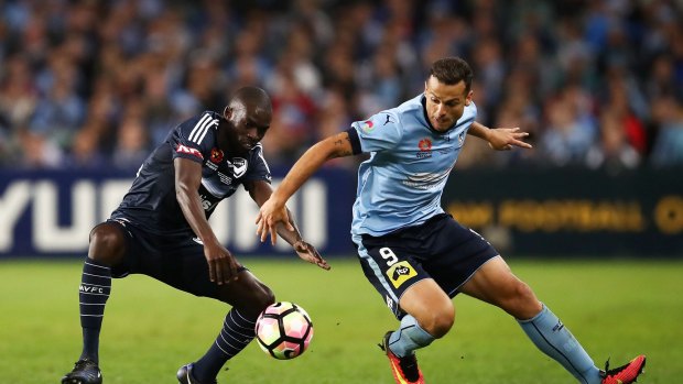 Finalising terms: Bobo, right, in action for the Sky Blues against Victory's Jason Geria in the A-League grand final.