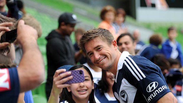 Smile of Victory: Harry Kewell signs autographs and poses for photos with fans yesterday.