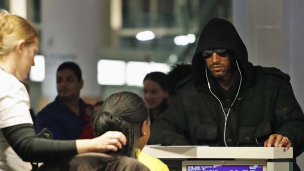 Sent home ... Nicolas Anelka checks in at the international airport in Cape Town.