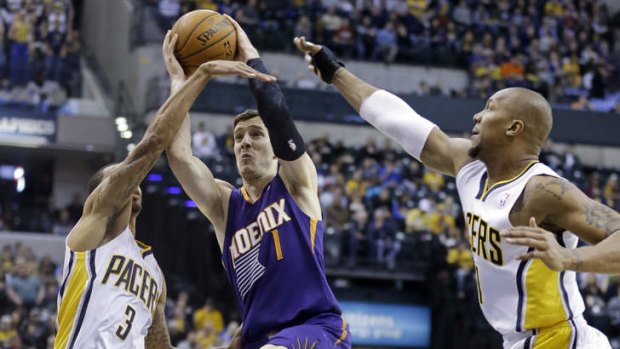 Phoenix Suns guard Goran Dragic shoots between Indiana Pacers guard George Hill and forward David West.