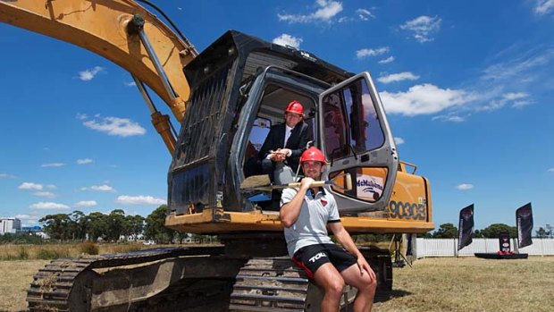 Digging deep: Coach James Hird puts Essendon captain Jobe Watson to work at the site of the Bombers' new facilities.
