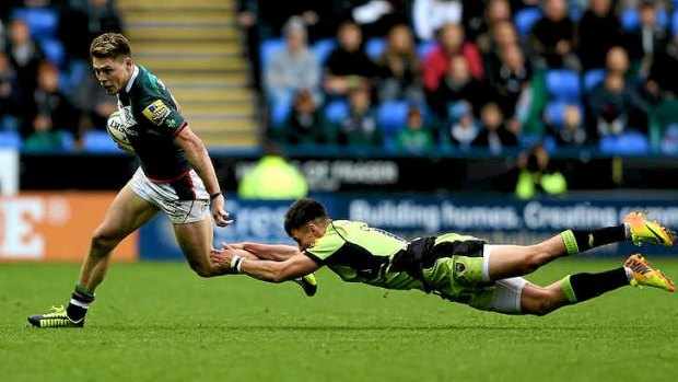 Star turn: James O'Connor evades a tackle from Tom Collins of Northampton Saints.
