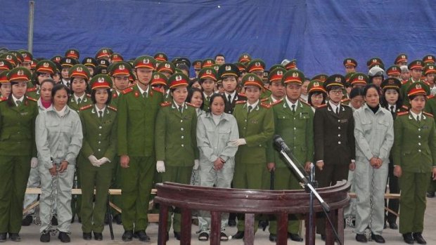 Facing death ... Defendants flanked by police stand and listen to their verdicts after a two-week long trial in the province of Quang Ninh, Vietnam.