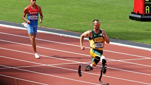 Crowd favourite ... Oscar Pistorius finishes comfortably second in the opening heat of the 400 metres,