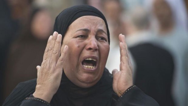 An Egyptian woman reacts outside the courtroom in Minya after Muslim Brotherhood leader Mohammed Badie and 682 other alleged Islamists were sentenced to death.