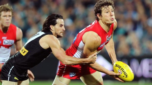 Port's Kane Mitchell tries to stop Kurt Tippett of the Swans passing the ball.