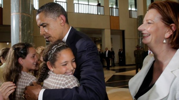 President Barack Obama is hugged by Chelsea Gallagher who is 'Prime Minister' of Dungong Primary School.