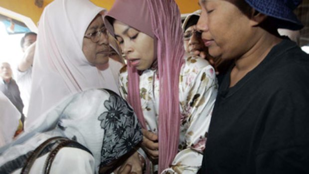 "I want to respect the law" . . . Mrs Kartika as she was taken by Islamic officials to be caned. Authorities have delayed the punishment until after Ramadan.