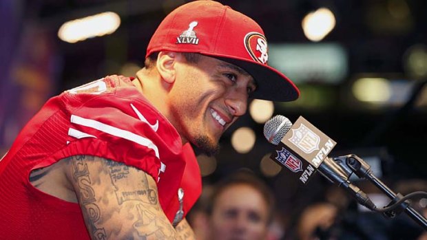 Inked in &#8230; quarterback Colin Kaepernick - and, inset, his tattoo-covered left arm - at a press conference before the Super Bowl.