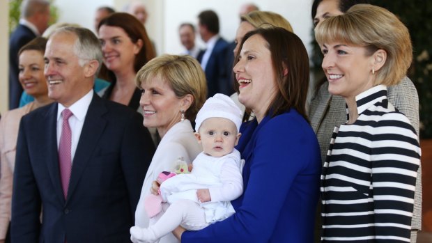 Kelly O'Dwyer's daughter Olivia joined the women in the ministry photo with Prime Minister Malcolm Turnbull and Julie Bishop after the swearing in ceremony at Government House on Monday September 21.