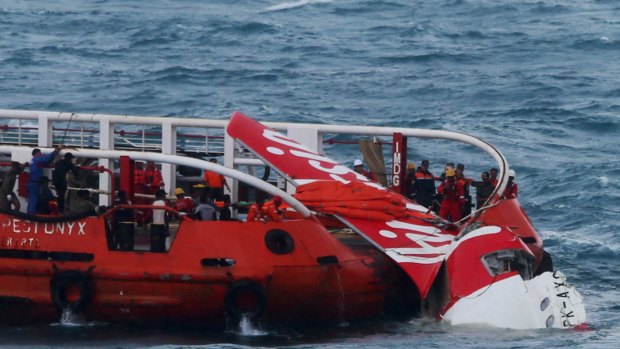 Stalled before crashing ... Indonesian search and rescue personnel pull wreckage of AirAsia flight QZ8501 onto the Crest Onyx ship at sea.