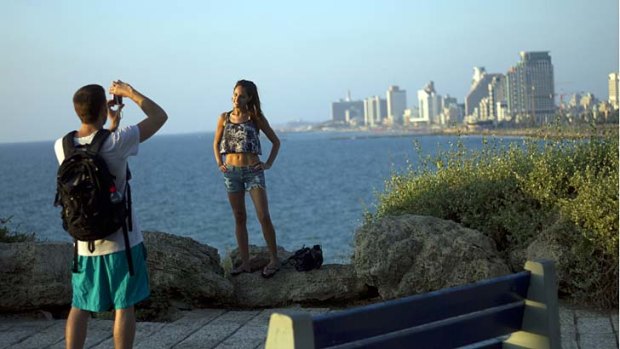 A tourist poses for a photo in Tel Aviv, Israel.