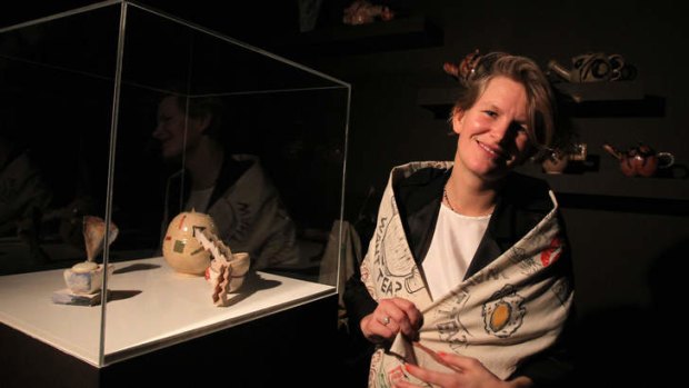 Laure Prouvost poses with her artwork entitled <i>Wantee</i>,  a video installation set among a mock-tea party setting.