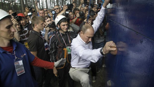 Macho man ... Russian Prime Minister Vladimir Putin scales a climbing wall during his visit to a summer camp run by the Nashi youth group.