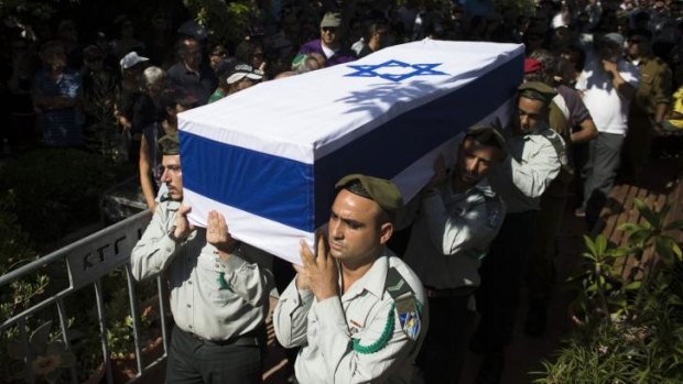 Israeli soldiers carry the flag-draped coffin of fallen reserve Israeli soldier Yair Ashkenazy  during his funeral in Rehovot, near Tel Aviv.