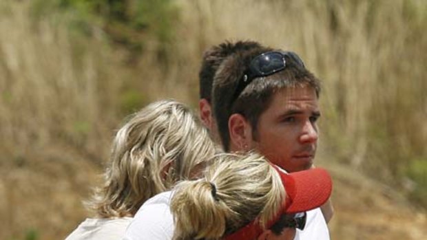 Lucky ones... survivors Mark Whatley and his mother Lisa, embrace at Albert Pike.