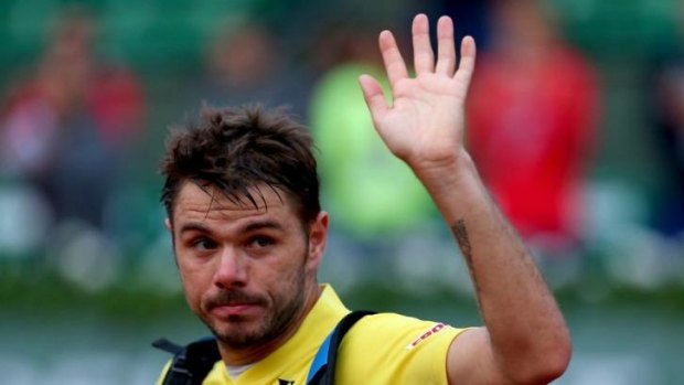 Stanislas Wawrinka leaves court after his first-round defeat.