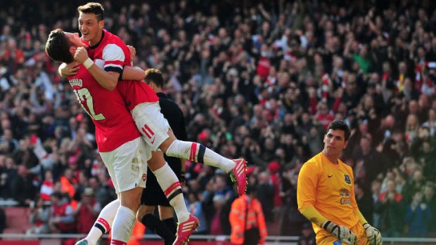 Double strike: Arsenal's striker Olivier Giroud (L) celebrates scoring his second goal with midfielder Mesut Ozil.