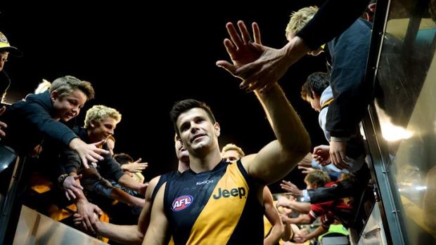 Sweet victory: Trent Cotchin with fans after the game.