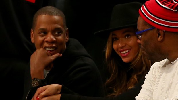 Nothing imminent: Brooklyn Nets part-owner Jay-Z with wife Beyonce during Monday's clash with Houston at the Barclays Center.