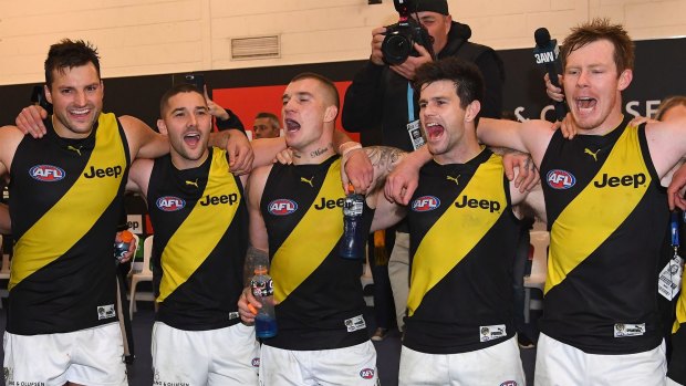 Dustin Martin (center) sings the Richmond song with his teammates following their win over North Melbourne. 