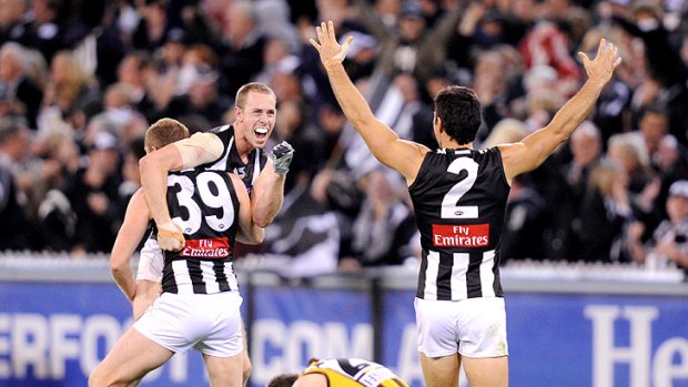 Collingwood players Nick Maxwell, Heath Shaw and Chris Tarrant celebrate the three-point victory over Hawthorn.