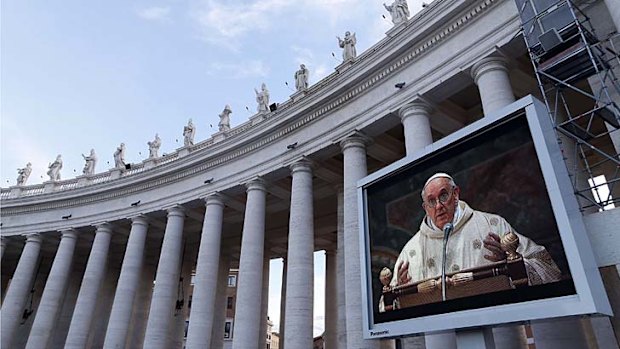 Mass on the big screen: Pope Francis' celebration of the Eucharist in the Sistine Chapel on Thursday was relayed to people gathered in St Peter's Square.