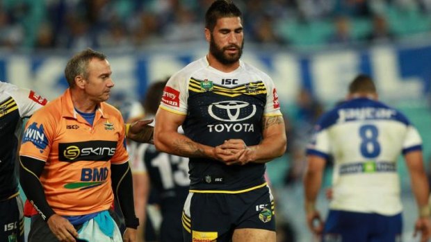 Cut down: Cowboys prop James Tamou leaves the field after falling badly playing the Bulldogs.
