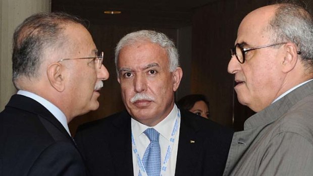 Foreign Minister of the Palestinian Authority, Riyad Al-Malki, centre, speaks to members of the Palestinian delegation.
