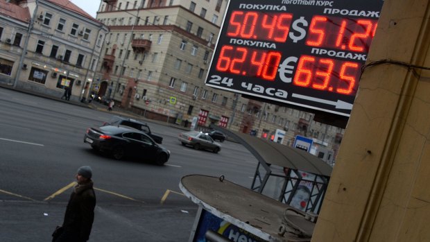 Shrugging it off: Russians are smiling despite a plunge in the rouble exchange rate.  