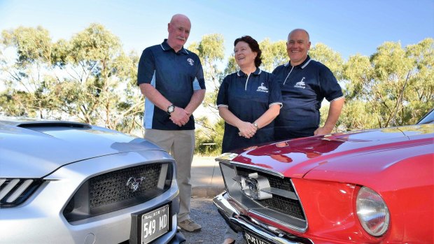 Canberra Mustang club members, from left, Mick Dainer, Sue Vilardi and Dominic Vilardi, with their cars.