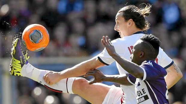 Hat-trick: Paris St Germain's Zlatan Ibrahimovic challenges Toulouse's Steev Yago.