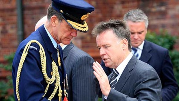 Shaken . . . the Defence Minister, Joel Fitzgibbon, with Air Chief Marshal Angus Houston yesterday.