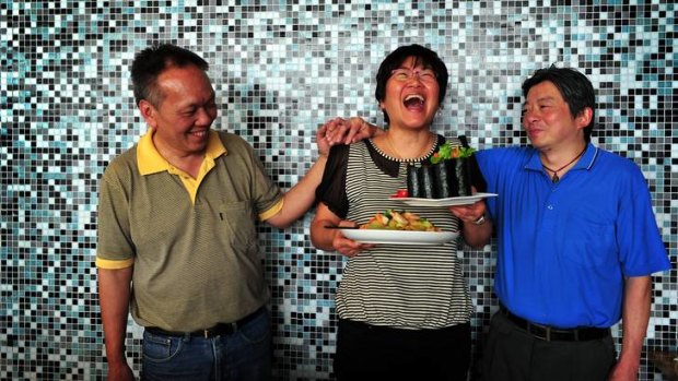 Portia Yeung (centre) is now manager of Wok and Roll in Fyshwick, pictured with her chefs Chi Ying Chan (left) and Wai Lun Chan.