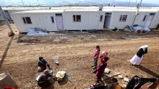 Displaced Iraqis from the Yazidi community cook at Dawodiya camp for internally displaced people in the Kurdish city of Dohuk.