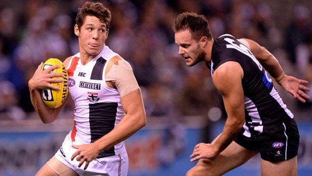 On the run: St Kilda's Arryn Siposs is chased by Magpie Nathan Brown.