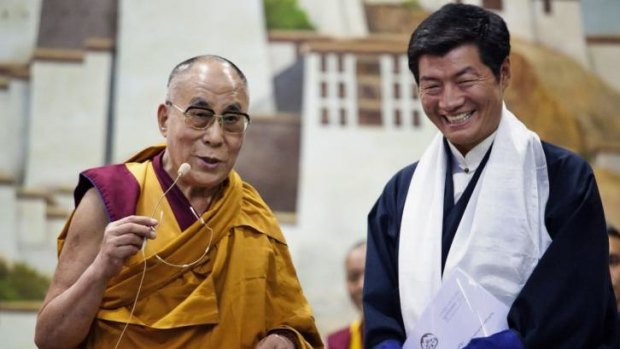 Lobsang Sangay, prime minister of the Tibetan government-in-exile, right, smiles as he listens to the Dalai Lama in Dharmsala, India.