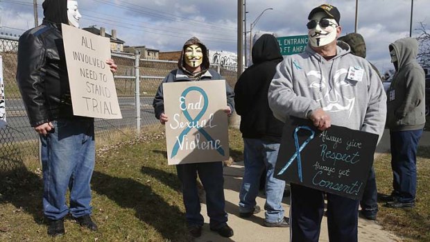A group of protesters in Anonymous masks outside court in Steubenville.