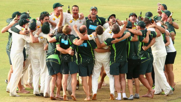 Australian players celebrate reclaiming the Ashes after their third Test victory in Perth.