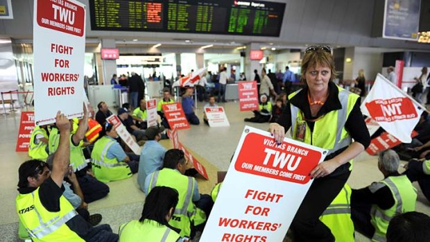 In the trenches ... Qantas engineers and ground staff  conduct a silent sit-in at the airline's domestic terminal at Melbourne Airport.