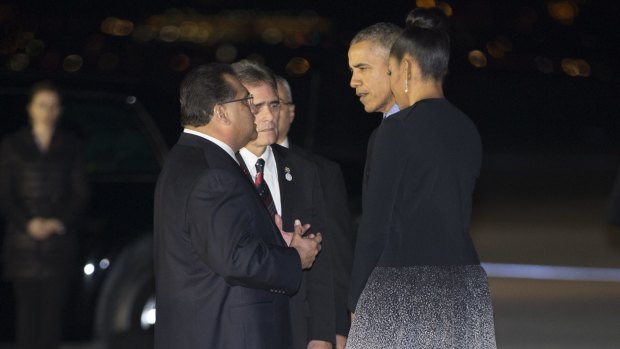President Barack Obama and first lady Michelle Obama talk with San Bernardino Mayor Carey Davis.
